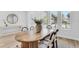 Bright dining room features modern oval wood table and stylish chairs illuminated by natural light at 2509 N Glenwood Dr, Tampa, FL 33602