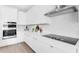 Sleek kitchen with white cabinetry and stainless steel appliances at 2509 N Glenwood Dr, Tampa, FL 33602