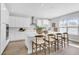 Bright and airy kitchen with white cabinets, an island, and four bar stools at 2509 N Glenwood Dr, Tampa, FL 33602
