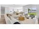 Bright living room featuring a white sectional sofa, stylish decor, and sliding glass doors to the backyard at 2509 N Glenwood Dr, Tampa, FL 33602