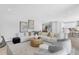 Bright living room featuring a white sectional sofa, stylish decor, and an open-concept layout at 2509 N Glenwood Dr, Tampa, FL 33602