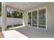 Covered patio with concrete flooring, leading to a fenced backyard, ideal for outdoor entertaining at 2509 N Glenwood Dr, Tampa, FL 33602