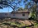 Back exterior of home featuring trees and landscaping at 4407 N 41St St, Tampa, FL 33610