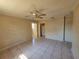 Bright living area featuring tiled floors, neutral walls, ceiling fan, and doorways leading to other rooms at 4407 N 41St St, Tampa, FL 33610