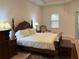 Large main bedroom with a king-size bed, nightstands and a comfortable seating area at 6948 Silver Sage Cir, Tampa, FL 33634