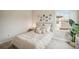 Bedroom with a neutral-toned bed, nightstand, and wall art at 14292 Swiss Bridge Dr, Riverview, FL 33579