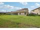 Home's backyard features a large grassy area at 14292 Swiss Bridge Dr, Riverview, FL 33579