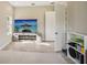 Bright home gym with large TV, storage shelving, and floor mats at 14292 Swiss Bridge Dr, Riverview, FL 33579