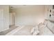Spacious bedroom with a neutral-toned bed and access to hallway at 14292 Swiss Bridge Dr, Riverview, FL 33579