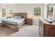Bright main bedroom featuring a platform bed and ample natural light at 14292 Swiss Bridge Dr, Riverview, FL 33579