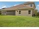 Home's back exterior with a screened patio and grassy yard at 14292 Swiss Bridge Dr, Riverview, FL 33579