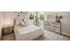Bedroom with a neutral-toned bed, dresser, and large windows at 14292 Swiss Bridge Dr, Riverview, FL 33579
