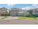 Two-story home with a three-car garage and landscaping at 14292 Swiss Bridge Dr, Riverview, FL 33579