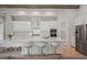 Spacious kitchen with white cabinets, quartz countertops, and an island with seating at 14292 Swiss Bridge Dr, Riverview, FL 33579