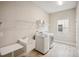 Laundry room with washer, dryer, utility sink, and shelving at 14292 Swiss Bridge Dr, Riverview, FL 33579