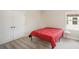 Simple bedroom with a red comforter and double doors at 14292 Swiss Bridge Dr, Riverview, FL 33579
