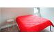 Bright bedroom with a red comforter and a side table at 14292 Swiss Bridge Dr, Riverview, FL 33579