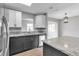 Modern kitchen with gray and white cabinets and granite countertops at 2220 Grenadier Dr # 2220, Sun City Center, FL 33573