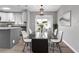 Modern dining area with glass table, stylish chairs, and kitchen access at 2220 Grenadier Dr # 2220, Sun City Center, FL 33573