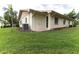 House exterior with AC unit and grassy backyard at 2220 Grenadier Dr # 2220, Sun City Center, FL 33573