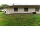 House exterior and grassy backyard with landscaping at 2220 Grenadier Dr # 2220, Sun City Center, FL 33573