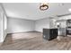 Open concept living room with wood-look floors and kitchen island view at 2220 Grenadier Dr # 2220, Sun City Center, FL 33573