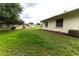 Grass backyard with partial view of neighboring house at 2220 Grenadier Dr # 2220, Sun City Center, FL 33573