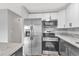 Updated kitchen featuring stainless steel appliances and granite countertops at 2220 Grenadier Dr # 2220, Sun City Center, FL 33573