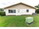 House exterior with AC unit and grassy backyard at 2220 Grenadier Dr # 2220, Sun City Center, FL 33573