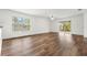 Bright living room featuring wood-look floors and sliding glass doors leading to backyard at 5093 Burnside St, North Port, FL 34291