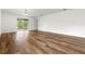 Spacious living room with wood-look floors and access to backyard at 5093 Burnside St, North Port, FL 34291