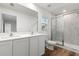 Bathroom boasts double vanity, a large mirror and a walk-in shower at 5093 Burnside St, North Port, FL 34291