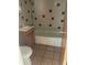 Bathroom with tiled walls and a bathtub at 10007 N 26Th St, Tampa, FL 33612