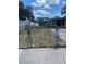 Backyard with chain-link fence, shed, and carport at 10007 N 26Th St, Tampa, FL 33612
