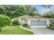 One-story home with screened garage and landscaped yard at 6928 Stephens Path, Zephyrhills, FL 33542