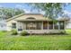 House back view with screened porch and green yard at 6928 Stephens Path, Zephyrhills, FL 33542