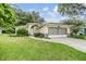 Charming single-story home with two-car garage and lush lawn at 6928 Stephens Path, Zephyrhills, FL 33542