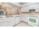 Well-equipped kitchen with white cabinets and modern appliances at 6928 Stephens Path, Zephyrhills, FL 33542