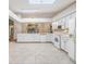 Bright kitchen featuring white cabinets and tile flooring at 6928 Stephens Path, Zephyrhills, FL 33542