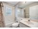 Bathroom with shower/tub combo, vanity and floral accents at 6928 Stephens Path, Zephyrhills, FL 33542