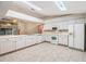 Galley-style kitchen with white cabinets and tile flooring at 6928 Stephens Path, Zephyrhills, FL 33542