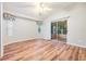 Spacious living room with wood-look floors and access to screened porch at 6928 Stephens Path, Zephyrhills, FL 33542