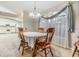 Cozy dining area with wood table and chairs, adjacent to kitchen at 6928 Stephens Path, Zephyrhills, FL 33542