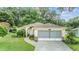 Single-story home with attached garage and landscaping at 6928 Stephens Path, Zephyrhills, FL 33542