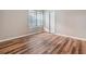 Well-lit bedroom featuring wood-look floors and a double-door closet at 6928 Stephens Path, Zephyrhills, FL 33542