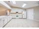 Kitchen with white cabinets and tile floors at 6928 Stephens Path, Zephyrhills, FL 33542