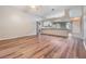 Bright living room features an open concept layout with kitchen access and wood-look flooring at 6928 Stephens Path, Zephyrhills, FL 33542