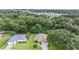 Aerial view showing a house nestled among trees and other houses at 6928 Stephens Path, Zephyrhills, FL 33542