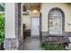Inviting front entrance with brick accents and arched window at 6928 Stephens Path, Zephyrhills, FL 33542