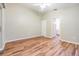 Bright bedroom with wood-look floors and access to bathroom at 6928 Stephens Path, Zephyrhills, FL 33542